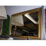 A bevelled wall mirror in gilt frame