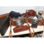 An assortment of vintage cameras, together with Swarovski binoculars,