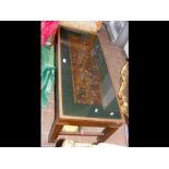 A decorative coffee table with carved inset panel