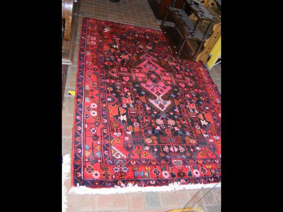 A Middle Eastern rug with red ground - 220cm x 145