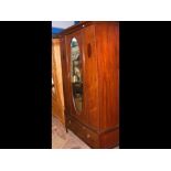 An Edwardian wardrobe with single central door and