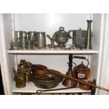 Two shelves of metal ware including pewter and cop