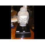 A Far Eastern carved marble head mounted on a blac