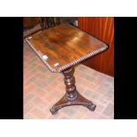 A 19th century mahogany wine table with shaped col