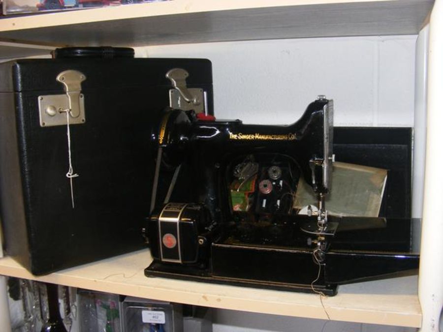 A Singer portable electric sewing machine No.221K1