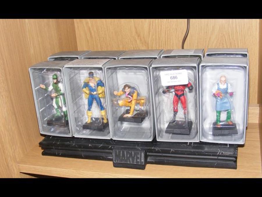 Ten boxed Marvel figures with stand