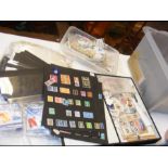 A box containing loose stamps and stamp accessorie