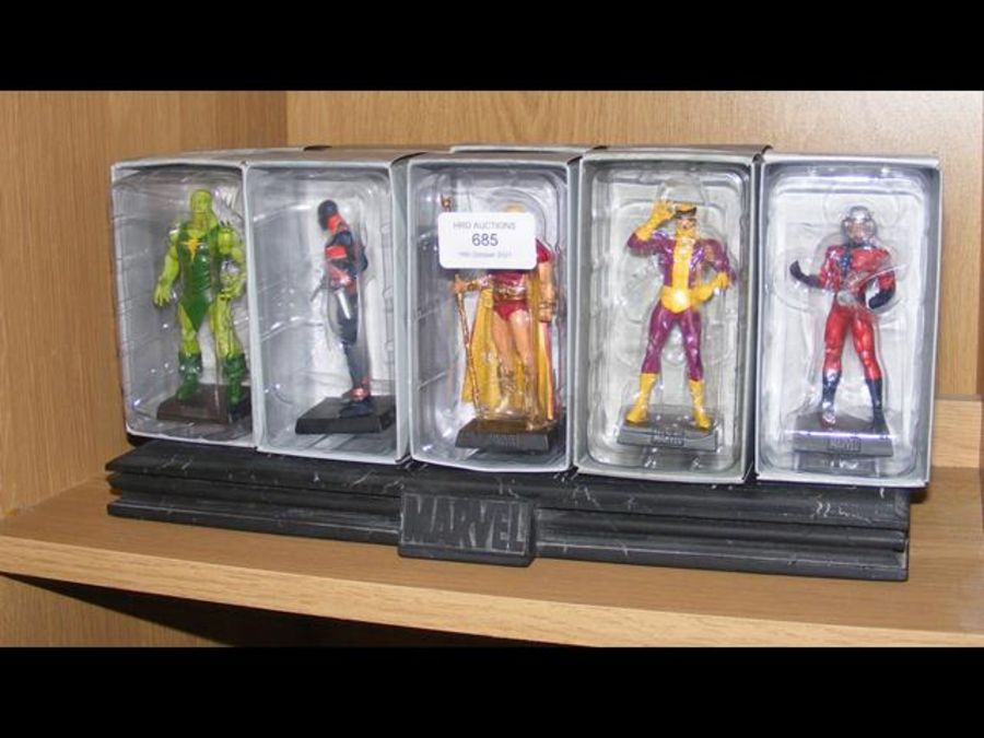 Ten boxed Marvel figures with stand