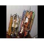 An assortment of costume necklaces on miniature ma