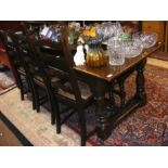 An oak refectory style dining table with a set of