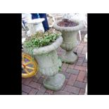 A pair of garden urns on stand