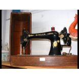 A vintage Singer sewing machine in carry case