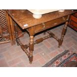 An oak side table with single drawer