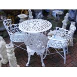 A painted aluminum garden table with three chairs