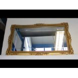 A decorative gilt rectangular wall mirror