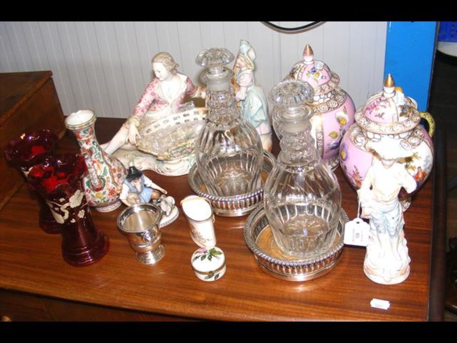 A pair of Georgian decanters on plated coasters to