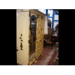 A Japanned antique wardrobe with mirrored bevelled