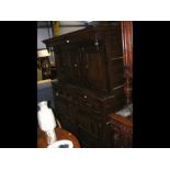 A period oak court cupboard with three panels to t