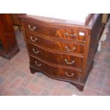 A reproduction serpentine fronted four drawer ches
