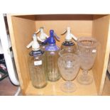 Four soda water siphons, together with two cut gla