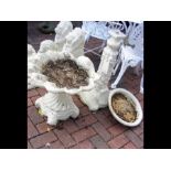 A garden bird bath and one other