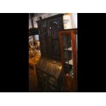 A Victorian carved oak bureau bookcase with drawer