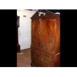 A Georgian mahogany linen press with panelled door