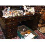 A reproduction pedestal desk with green leather to