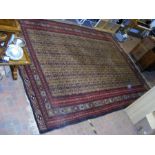 A large Middle Eastern carpet with geometric borde