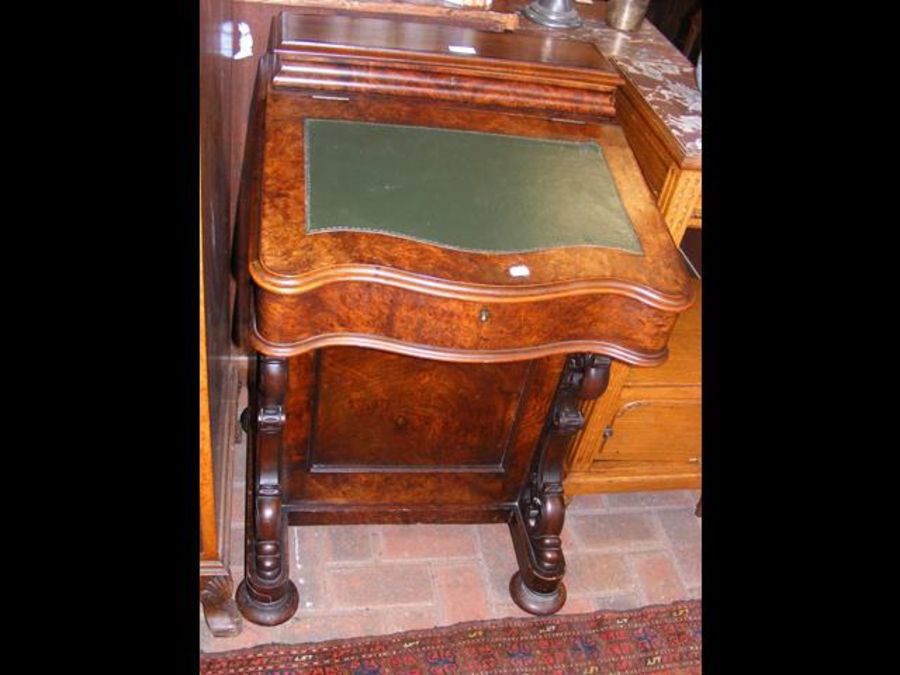 A Victorian walnut Davenport desk with inkwells to