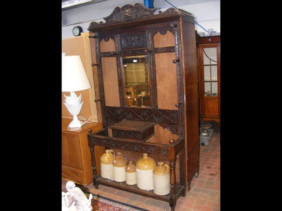 A Victorian carved oak hall stand with mirrored ba