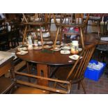 An extending Ercol dining table with the matching