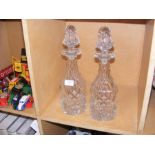 A pair of cut glass decanters with stoppers