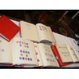 Six red stamp albums containing GB collectable sta