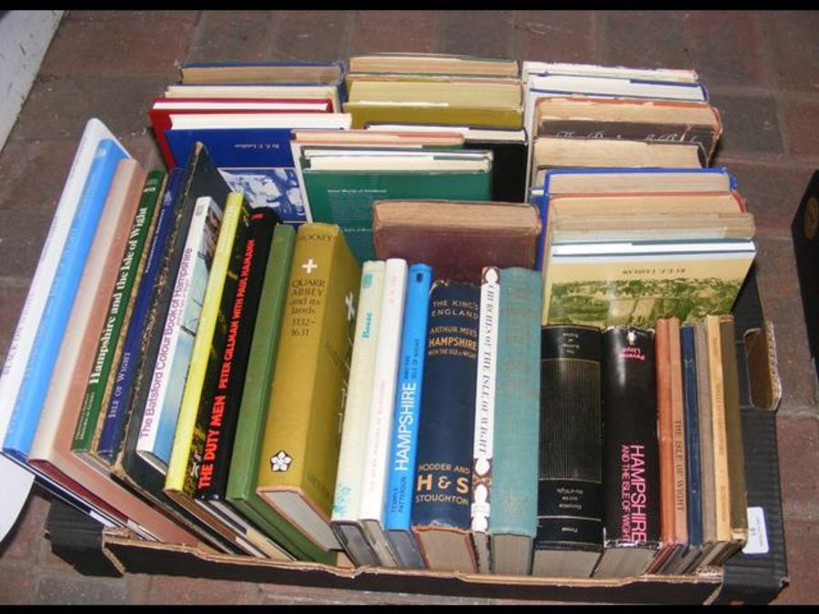 A box containing various hardback volumes relating