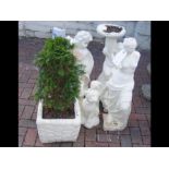 Seven garden ornaments together with a small plant