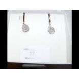 A pair of gold and diamond pendant earrings
