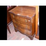 A serpentine fronted chest of three drawers