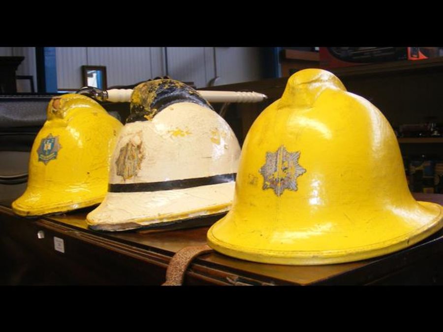 Three vintage firemen helmets