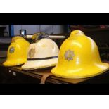 Three vintage firemen helmets