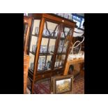 A two door Edwardian display cabinet with drawers