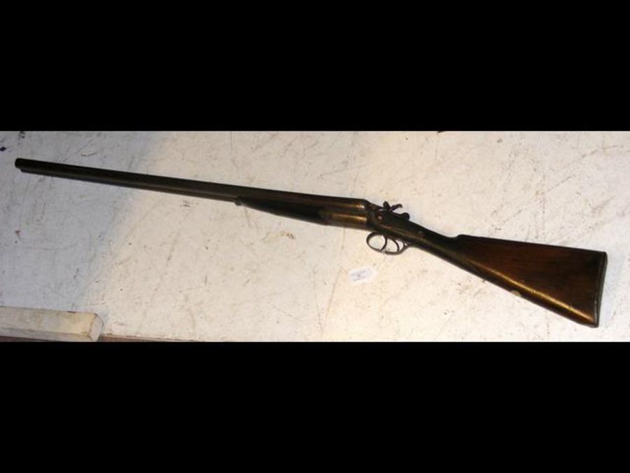 An antique deactivated side by side shotgun - 118c