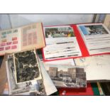 A collection of postcards, stamps and envelopes re