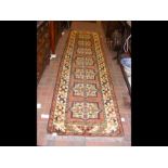 A Middle Eastern style runner with geometric borde