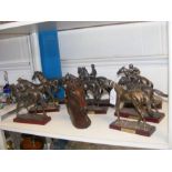 A number of bronzed race horse figurines