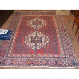 A large Middle Eastern rug with geometric border -