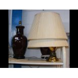 A pair of burgundy table lamps, together with one