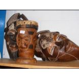 Two African carved wooden masks, together with a t