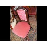 An antique button back nursing chair upholstered i