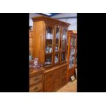 A hardwood dresser with glazed upper section and c